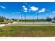 Waterford bocce court with shade trees near a pond with bench seating at 25317 E Lenox Cir, Punta Gorda, FL 33950