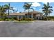 Community clubhouse at Waterford with lush landscaping and easy access parking at 25317 E Lenox Cir, Punta Gorda, FL 33950