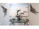 Foyer decor featuring a beach scene print, glass-topped console table and marine-themed decor at 25317 E Lenox Cir, Punta Gorda, FL 33950