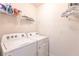 Functional laundry room with a side-by-side washer and dryer and wire shelving for storage at 25317 E Lenox Cir, Punta Gorda, FL 33950