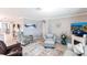 Spacious living room with tile flooring, cozy seating, fireplace and a view of a boat harbor at 25317 E Lenox Cir, Punta Gorda, FL 33950