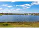 Scenic pond view with a water fountain and well-maintained grassy surroundings at 25317 E Lenox Cir, Punta Gorda, FL 33950