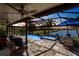 Tranquil screened pool with a spa, serene water views, and comfortable lounge seating at 25317 E Lenox Cir, Punta Gorda, FL 33950