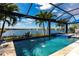 Sparkling swimming pool featuring a serene lake backdrop and views of the landscaped backyard at 25317 E Lenox Cir, Punta Gorda, FL 33950