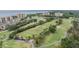 Aerial view of golf course and condo community with water views and lush landscaping at 2616 Cove Cay Dr # 301, Clearwater, FL 33760