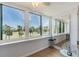 Sunroom with expansive windows showcasing scenic views of palm trees and lush greenery at 2616 Cove Cay Dr # 301, Clearwater, FL 33760