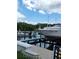 Private boat dock with multiple boats, a boat lift, and waterfront views at 2616 Cove Cay Dr # 301, Clearwater, FL 33760