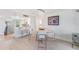 Open-concept dining area with stylish lighting and adjacent breakfast bar and kitchen at 2616 Cove Cay Dr # 301, Clearwater, FL 33760