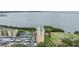 Exterior aerial view of waterfront condo buildings surrounded by greenspace and water views at 2616 Cove Cay Dr # 301, Clearwater, FL 33760