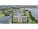 Aerial view of condo buildings surrounded by lush landscaping, golf courses, and picturesque water views at 2616 Cove Cay Dr # 301, Clearwater, FL 33760