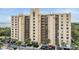 Multi-story condo building with balconies, lush landscaping, and ample parking at 2616 Cove Cay Dr # 301, Clearwater, FL 33760