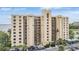 Multi-story condo building with balconies, lush landscaping, and ample parking at 2616 Cove Cay Dr # 301, Clearwater, FL 33760
