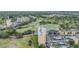 Aerial view of the exterior of condo buildings near a golf course, pond, and parking at 2616 Cove Cay Dr # 301, Clearwater, FL 33760