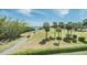 Scenic golf course view with lush greens, palm trees, and blue waters in the background at 2616 Cove Cay Dr # 301, Clearwater, FL 33760