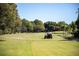 Beautiful golf course view with green grass, trees, and a golfer in a golf cart at 2616 Cove Cay Dr # 301, Clearwater, FL 33760
