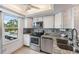 Modern kitchen features stainless steel appliances, granite countertops, and mosaic backsplash at 2616 Cove Cay Dr # 301, Clearwater, FL 33760