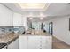 Well-equipped kitchen with granite countertops and stainless steel appliances overlooking the dining area at 2616 Cove Cay Dr # 301, Clearwater, FL 33760