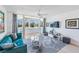 Bright living room with a comfortable blue sofa, scenic views, and stylish contemporary decor at 2616 Cove Cay Dr # 301, Clearwater, FL 33760
