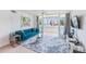 Bright living room with contemporary furnishings and a view of the water from the balcony at 2616 Cove Cay Dr # 301, Clearwater, FL 33760