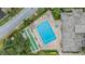 Aerial view of a community pool, spa, shuffleboard, lounging area, and tropical landscaping at 2616 Cove Cay Dr # 301, Clearwater, FL 33760