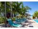 Community pool has many sun loungers and plenty of tropical plants for shade at 2616 Cove Cay Dr # 301, Clearwater, FL 33760
