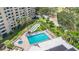 A stunning aerial view of a pool, hot tub, shuffleboard court, and manicured landscaping at 2621 Cove Cay Dr # 204, Clearwater, FL 33760