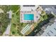 Aerial view of a condo community featuring a pool, shuffleboard court and lush landscaping at 2621 Cove Cay Dr # 204, Clearwater, FL 33760