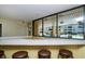 Indoor bar area overlooking a sparkling pool offering a relaxed ambiance and seamless indoor-outdoor lifestyle at 2621 Cove Cay Dr # 204, Clearwater, FL 33760