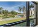 Window view of a refreshing pool, shuffleboard and well-kept grounds with lush trees at 2621 Cove Cay Dr # 204, Clearwater, FL 33760