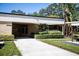 Well-maintained building facade featuring a covered entrance and neatly landscaped grounds, showcasing curb appeal at 2621 Cove Cay Dr # 204, Clearwater, FL 33760