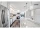 Modern kitchen featuring stainless steel appliances, granite countertops and white cabinets at 2621 Cove Cay Dr # 204, Clearwater, FL 33760