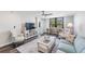 Bright living room features modern furnishings and a window view at 2621 Cove Cay Dr # 204, Clearwater, FL 33760