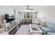 Open-concept living room with comfortable furniture, natural light, and dark floors at 2621 Cove Cay Dr # 204, Clearwater, FL 33760
