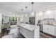 Open kitchen and living area with stainless steel appliances, a large island and comfortable furniture at 2621 Cove Cay Dr # 204, Clearwater, FL 33760