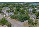 An aerial view highlights the house's placement on a corner lot, amidst mature trees within a residential area at 3001 9Th N Ave, St Petersburg, FL 33713