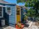 This cozy backyard shows a bright yellow door and mature plants at 3001 9Th N Ave, St Petersburg, FL 33713