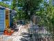 Cozy backyard with greenery, a stone walkway, and a partial white picket fence at 3001 9Th N Ave, St Petersburg, FL 33713