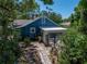 This backyard shows mature plants, a stone path, and a patio at 3001 9Th N Ave, St Petersburg, FL 33713