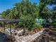 Secluded backyard patio with lush tropical landscaping, stone pathway, and a seating area perfect for relaxation at 3001 9Th N Ave, St Petersburg, FL 33713