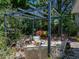 Backyard seating area under a pergola, surrounded by greenery and colorful flowers at 3001 9Th N Ave, St Petersburg, FL 33713