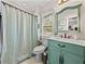 Charming bathroom features a vanity with a green base, shower and neutral decor at 3001 9Th N Ave, St Petersburg, FL 33713