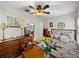 Spacious bedroom with decorative dresser, bed frame, ceiling fan, and bright lighting at 3001 9Th N Ave, St Petersburg, FL 33713