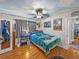 Cozy bedroom features unique ceiling design, a ceiling fan, and hardwood floors at 3001 9Th N Ave, St Petersburg, FL 33713