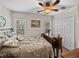 Comfortable bedroom features a decorative bed frame, ceiling fan, and natural light at 3001 9Th N Ave, St Petersburg, FL 33713