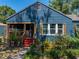 Inviting home featuring a screened porch, colorful chairs, and charming curb appeal at 3001 9Th N Ave, St Petersburg, FL 33713