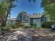 Well-maintained home featuring a lawn, decorative shutters, and a screened-in porch at 3001 9Th N Ave, St Petersburg, FL 33713