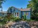 Quaint home with a manicured lawn, decorative shutters, a brick chimney, and a screened-in porch at 3001 9Th N Ave, St Petersburg, FL 33713