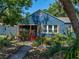 Charming blue home with a screened-in porch, decorative shutters, and lush landscaping creating curb appeal at 3001 9Th N Ave, St Petersburg, FL 33713