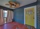 Enclosed porch with wood siding, neutral curtains, and a vibrant yellow front door, a cozy space to enjoy the outdoors at 3001 9Th N Ave, St Petersburg, FL 33713