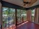 Enclosed porch with wood railing and a ceiling fan that provides a relaxing transition between the interior and exterior at 3001 9Th N Ave, St Petersburg, FL 33713